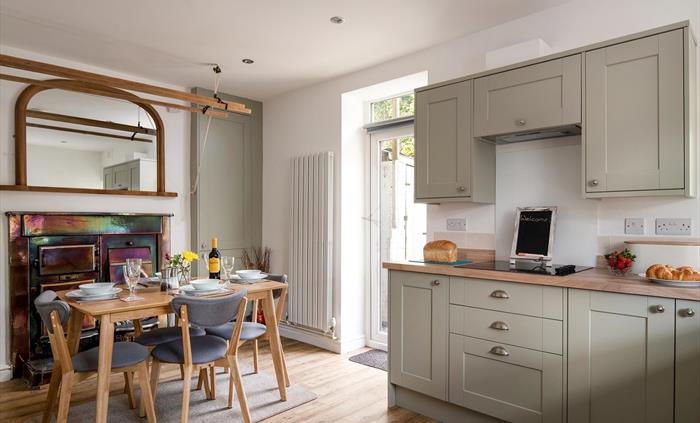 The kitchen is large and spacious, the table will seat 6 but can also be extended for extra space.  There is an antique range with an open fire.  The